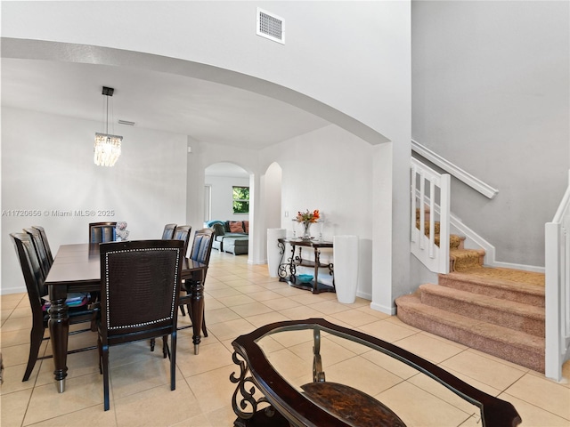 tiled dining space featuring an inviting chandelier