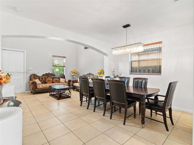 tiled dining space with an inviting chandelier