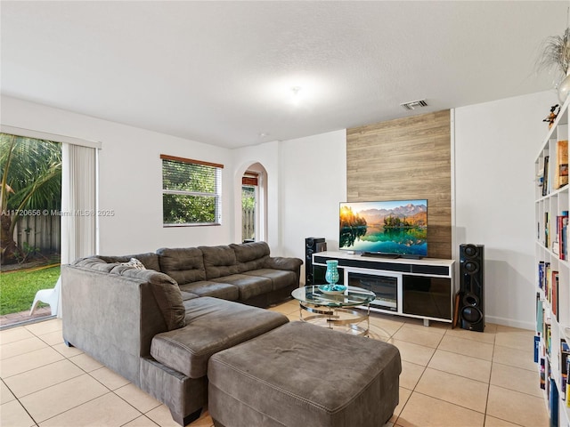 living room featuring light tile patterned flooring and a textured ceiling