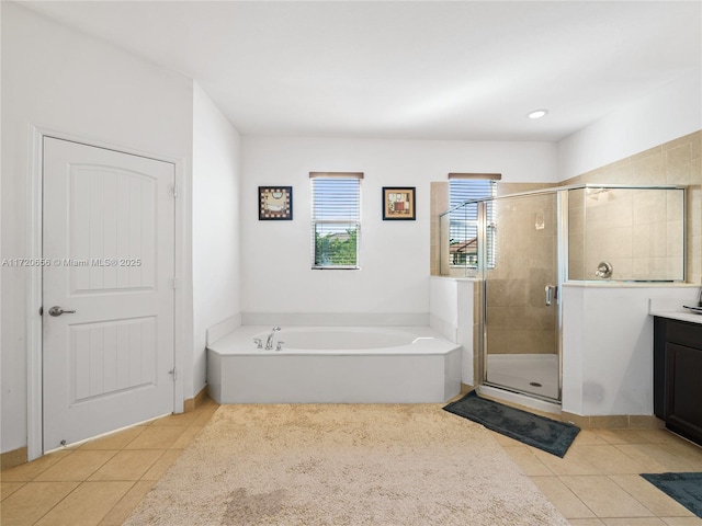 bathroom with tile patterned flooring, vanity, and independent shower and bath