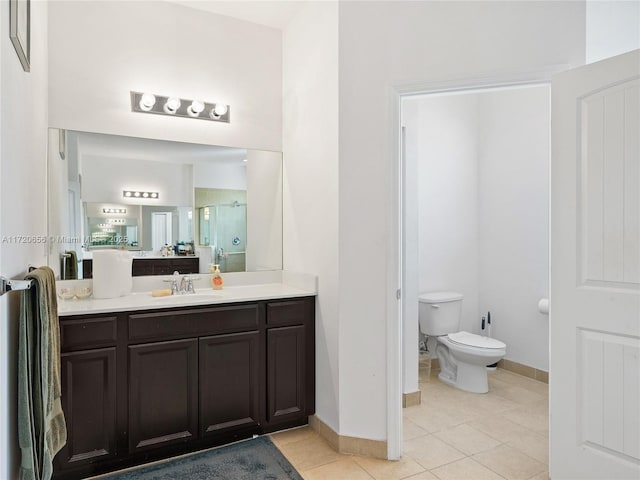 bathroom with tile patterned flooring, vanity, toilet, and walk in shower