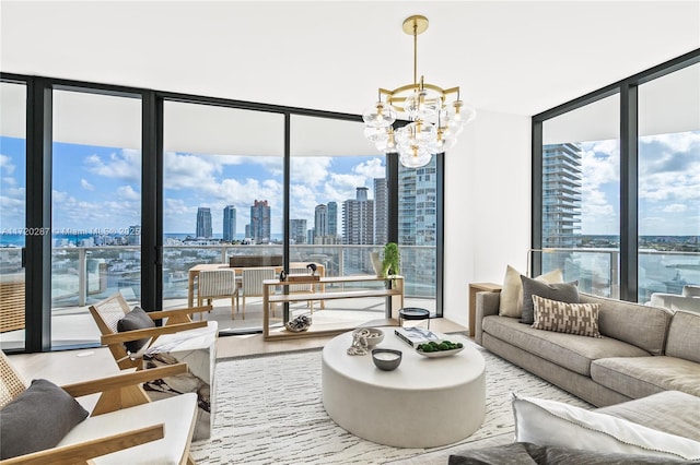 living room with an inviting chandelier, a wealth of natural light, and hardwood / wood-style floors