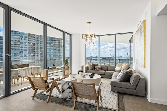 living room featuring a wall of windows, an inviting chandelier, and a water view