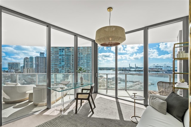 sunroom featuring a healthy amount of sunlight and a water view