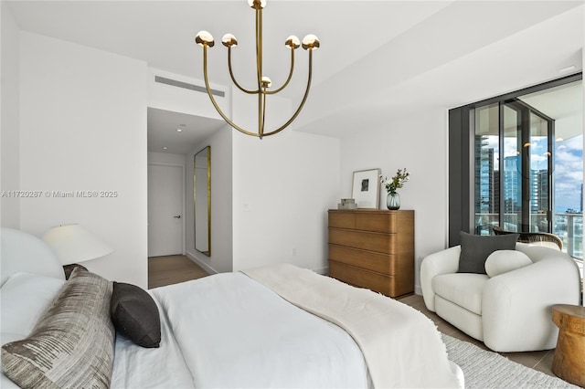 bedroom featuring floor to ceiling windows and a notable chandelier