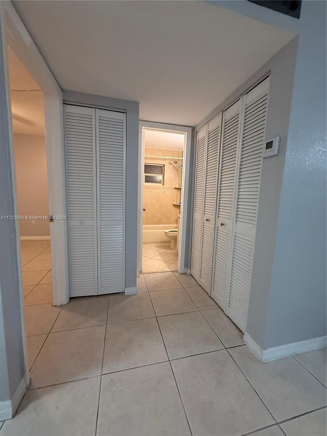 hallway with light tile patterned floors