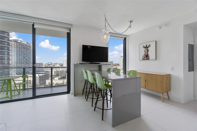 tiled dining space with electric panel and floor to ceiling windows