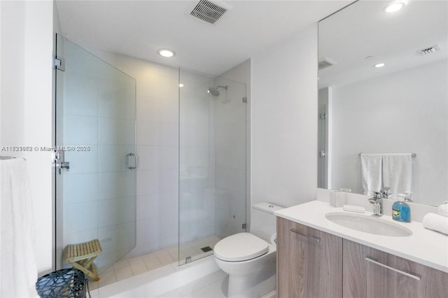 bathroom with tile patterned floors, vanity, toilet, and an enclosed shower