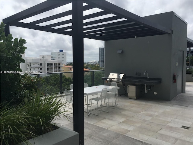 view of patio / terrace featuring a grill and a wet bar