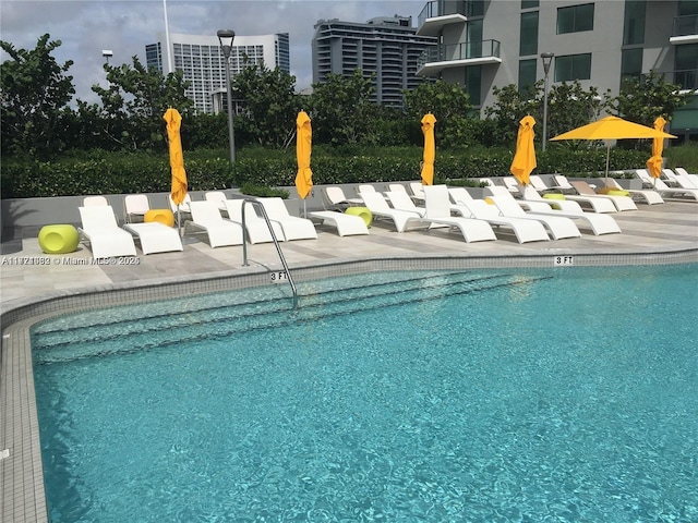 view of swimming pool with a patio