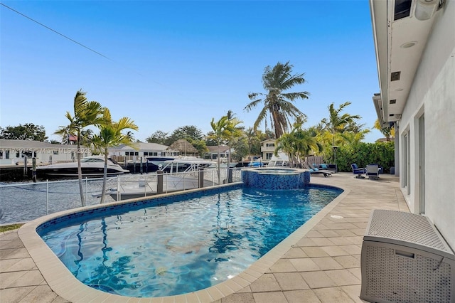 view of swimming pool with an in ground hot tub and a patio area