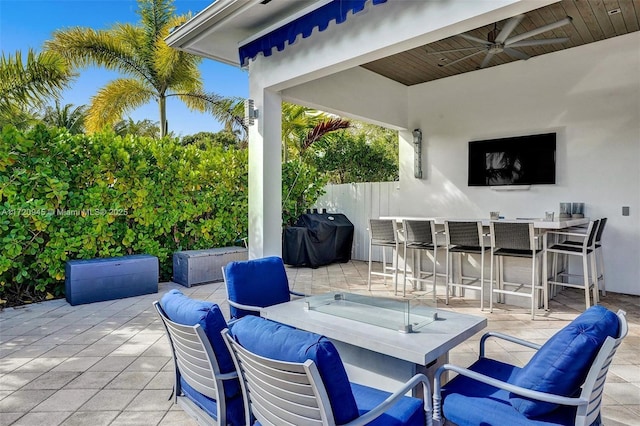 view of patio / terrace with ceiling fan, exterior bar, and area for grilling