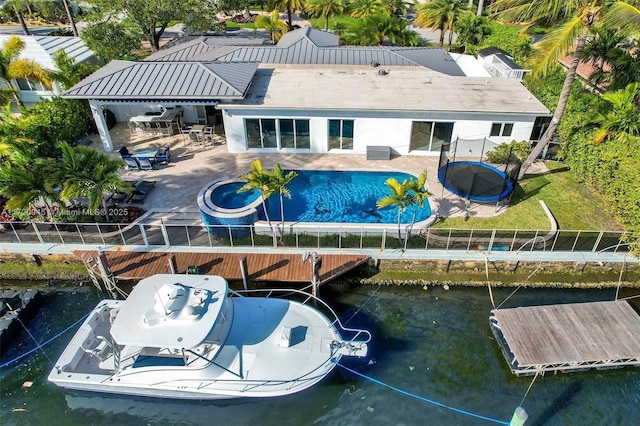 rear view of property featuring a patio area and a water view