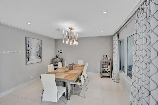 dining room with crown molding, light tile patterned floors, and a chandelier