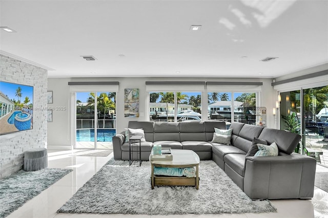 living room with ornamental molding and light tile patterned floors