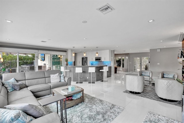 living room with light tile patterned floors and a healthy amount of sunlight