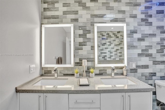 bathroom with tasteful backsplash, vanity, and toilet