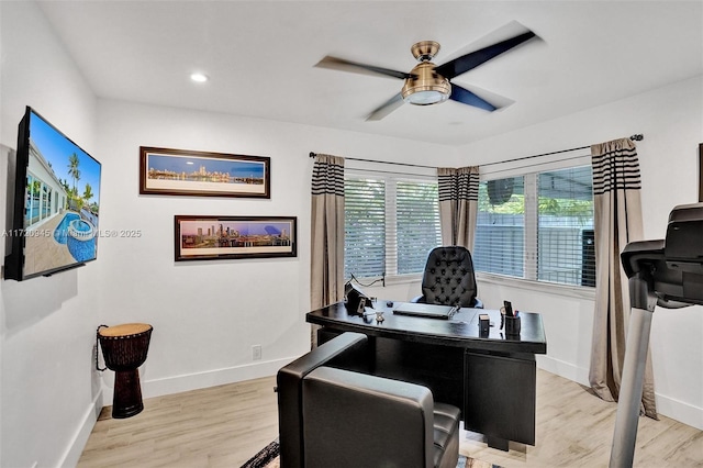 home office featuring ceiling fan and light hardwood / wood-style floors