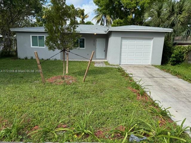 ranch-style home with a front lawn and a garage