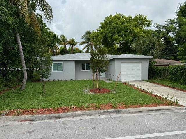 ranch-style home with a garage and a front yard