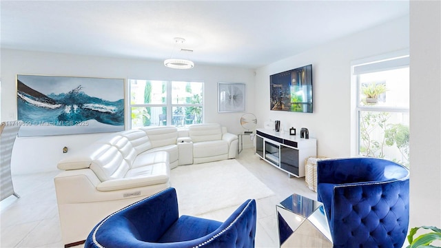 living room featuring a healthy amount of sunlight and tile patterned flooring