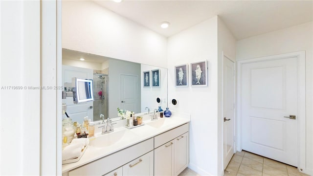 bathroom with walk in shower, vanity, and tile patterned flooring