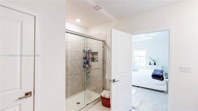 bathroom featuring a shower with shower door