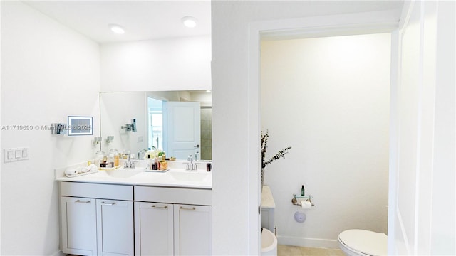 bathroom featuring vanity and toilet