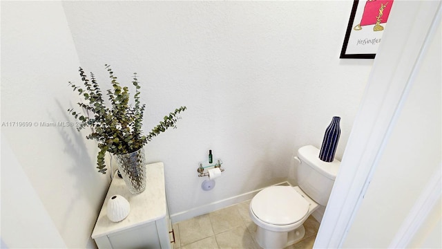 bathroom featuring toilet and tile patterned flooring