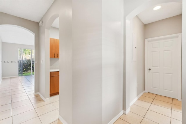 hall featuring light tile patterned floors