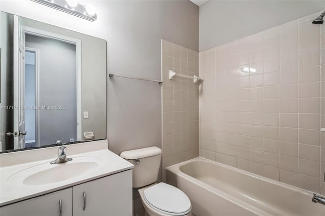 full bathroom featuring tiled shower / bath combo, vanity, and toilet