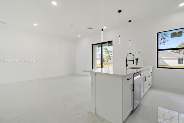 kitchen with white cabinetry, sink, dishwasher, decorative light fixtures, and a center island with sink