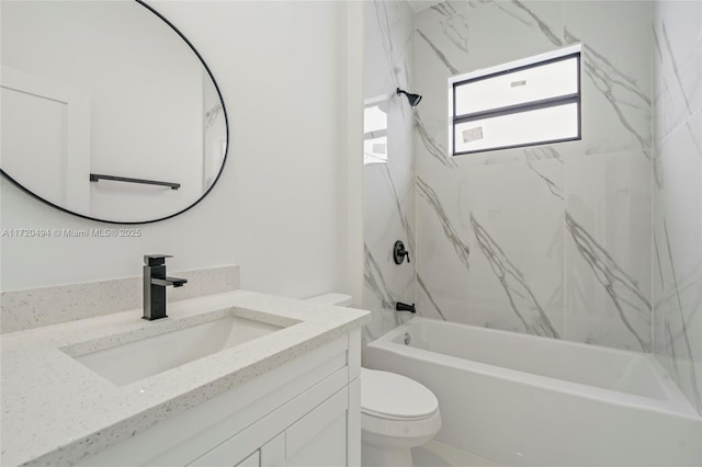 full bathroom with toilet, vanity, and tiled shower / bath