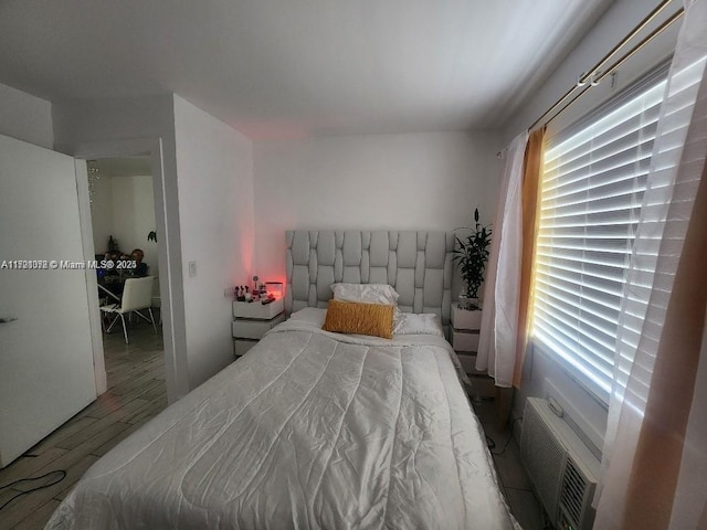 bedroom with hardwood / wood-style floors