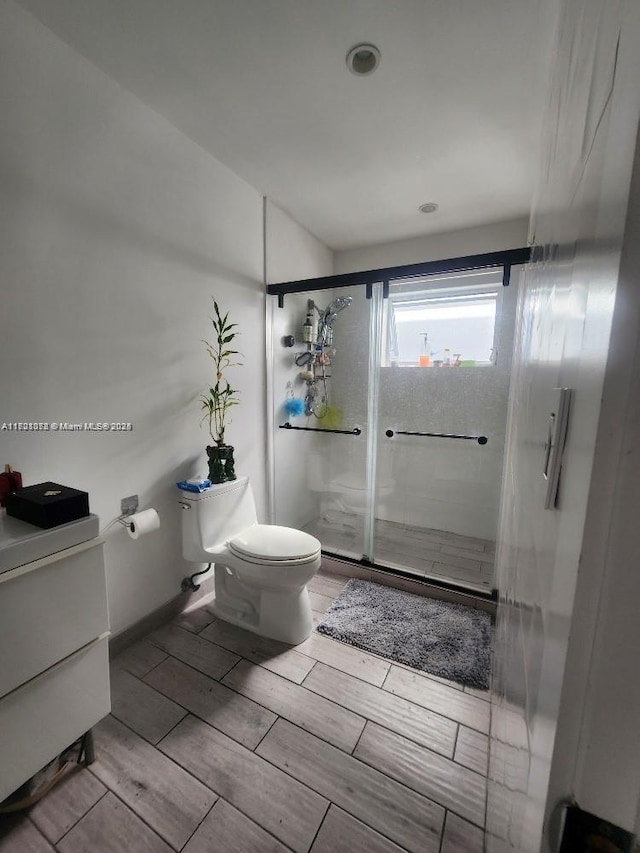 bathroom with walk in shower and toilet