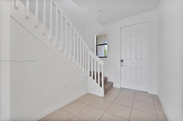 foyer entrance featuring light tile patterned flooring