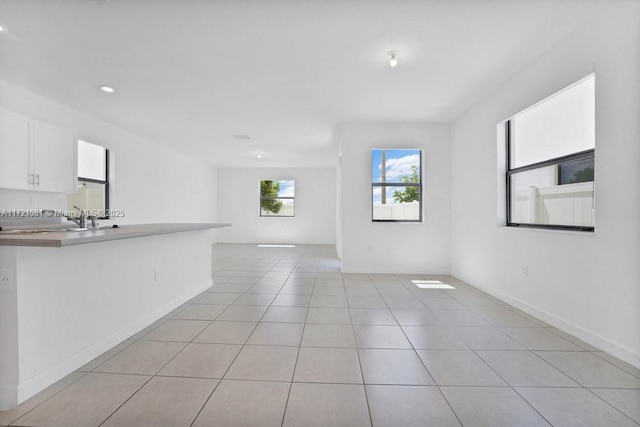 unfurnished living room with light tile patterned flooring