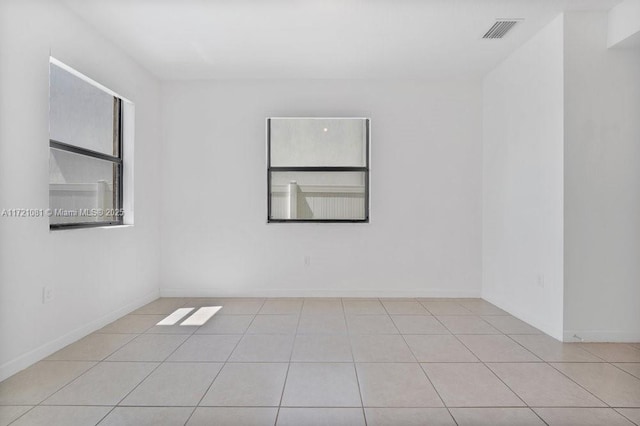 spare room featuring light tile patterned floors