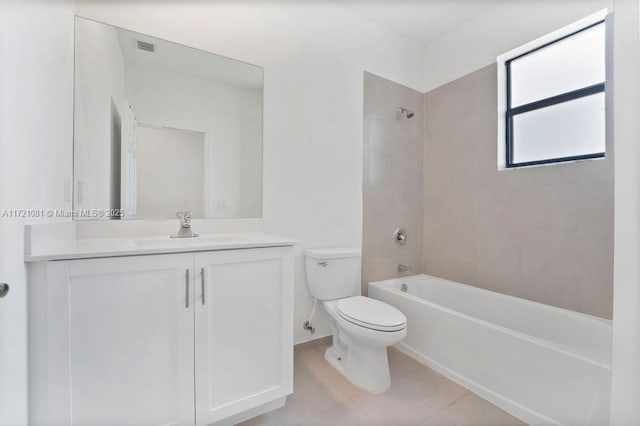 full bathroom featuring tile patterned flooring, vanity, toilet, and tiled shower / bath