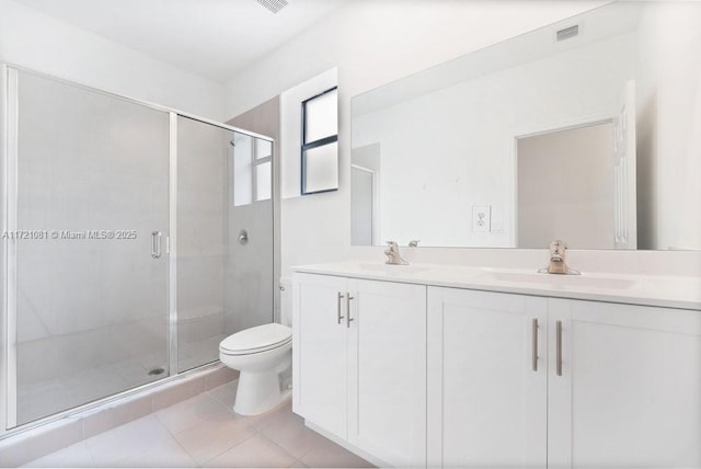 bathroom featuring tile patterned flooring, vanity, an enclosed shower, and toilet