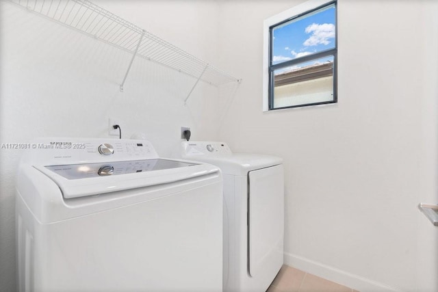 washroom featuring independent washer and dryer and light tile patterned floors