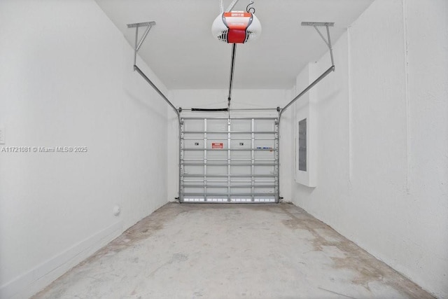 garage with electric panel and a garage door opener