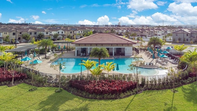 view of pool with a lawn and a patio