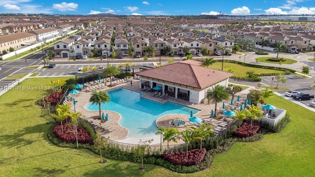 view of pool with a patio area and a lawn