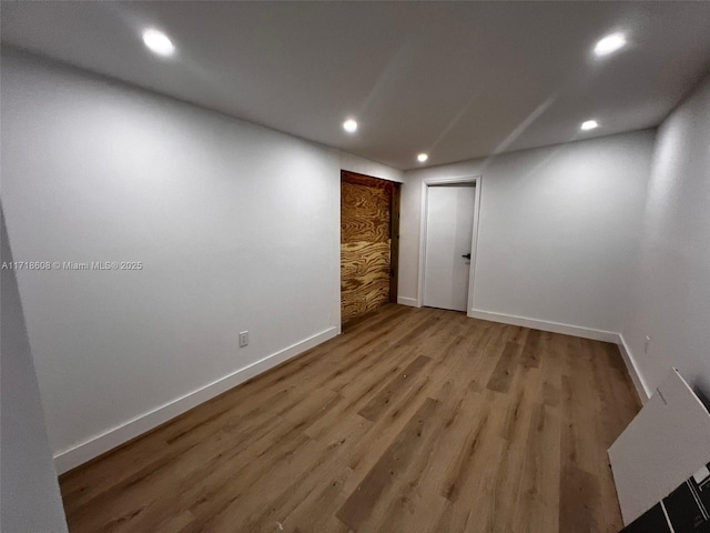 spare room with hardwood / wood-style flooring