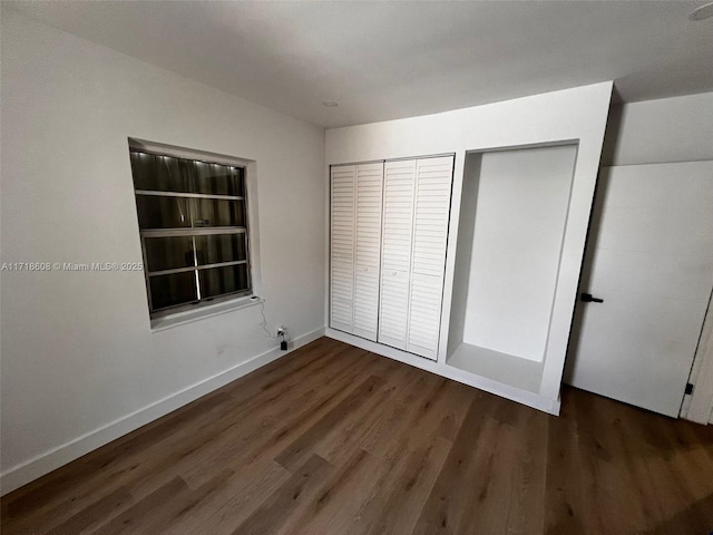 unfurnished bedroom featuring dark wood-type flooring