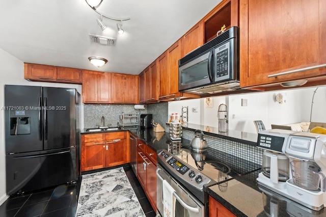 kitchen with tasteful backsplash, sink, dark stone counters, light tile patterned floors, and black appliances