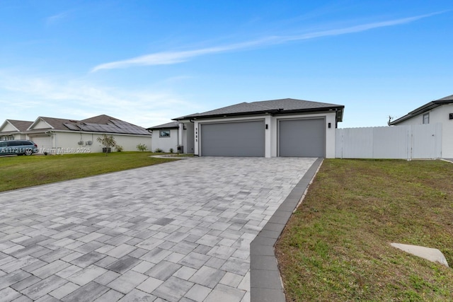 view of front of house featuring a front yard and a garage