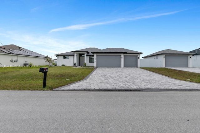 view of front of house with a front yard and a garage