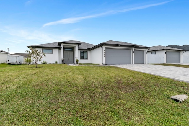 view of front of home with a front yard and a garage